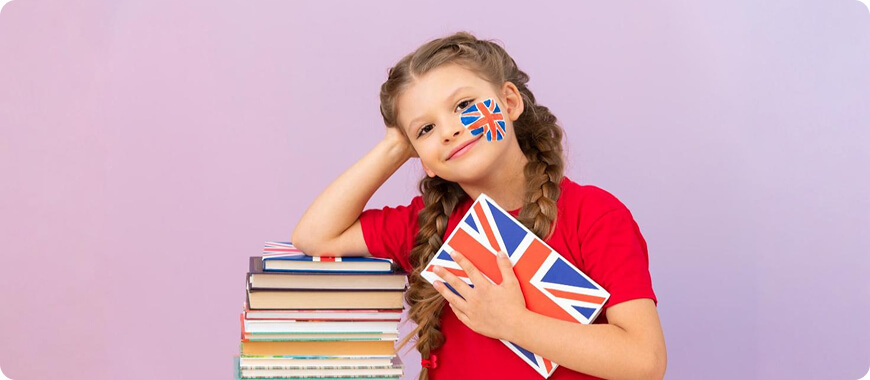 Child with British flag on face and books, embracing English learning