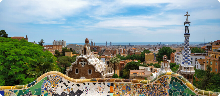 Colourful mosaic view of Barcelona from Park Güell on a sunny day.